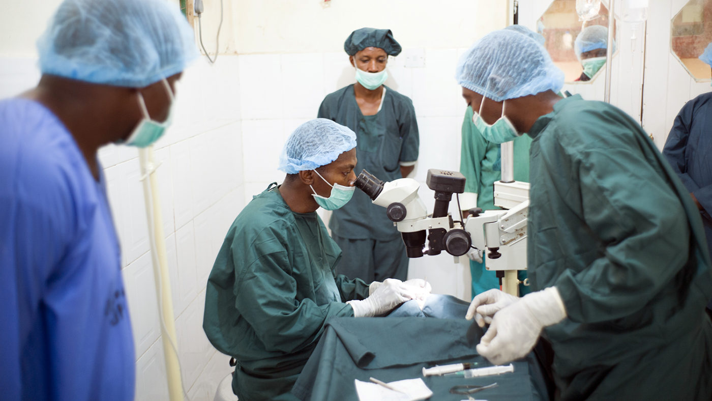 Health workers carrying out an eye operation.