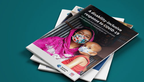A pile of three reports. The top one is entitled: A disability-inclusive response to COVID-19 - four lessons learned about including people with disabilities in humanitarian aid. The image shows a mother holding a child, both wearing facemasks. The cover includes an Inclusive Futures and UK aid logo.