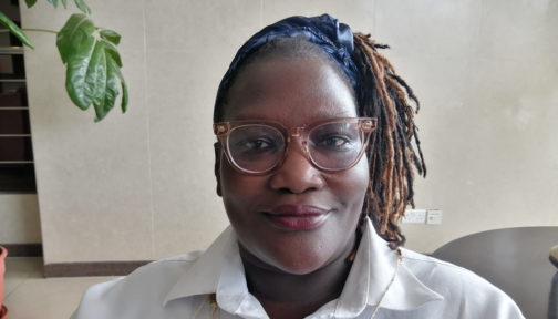 A head and shoulders photo of Easter Okech, wearing glasses with her hair in a ponytail.