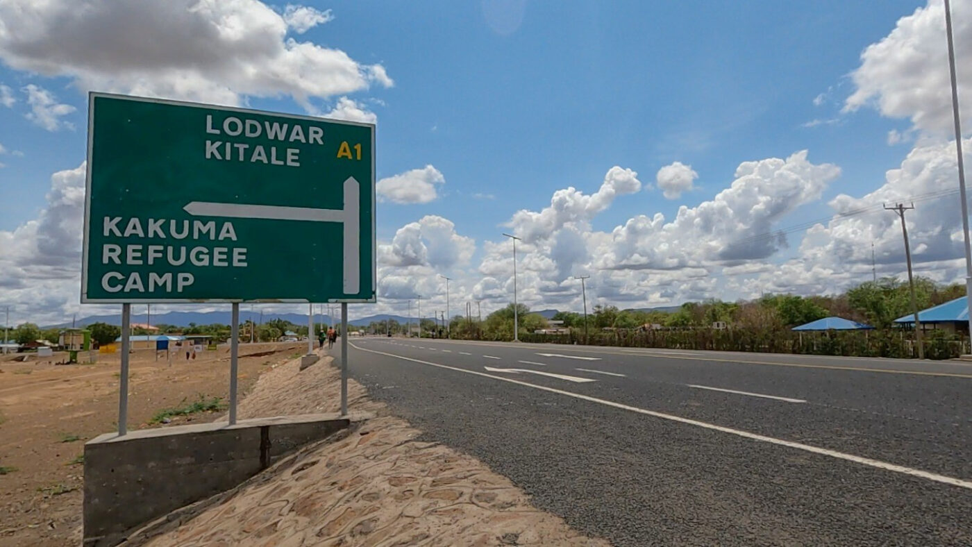 A road sign with two arrows, one reads Kakuma Refugee Camp and the other one is Lodwar Kitale