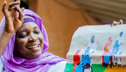 Inclusion champion Ramatu holds up an illustration during an inclusive family planning workshop in Nigeria.